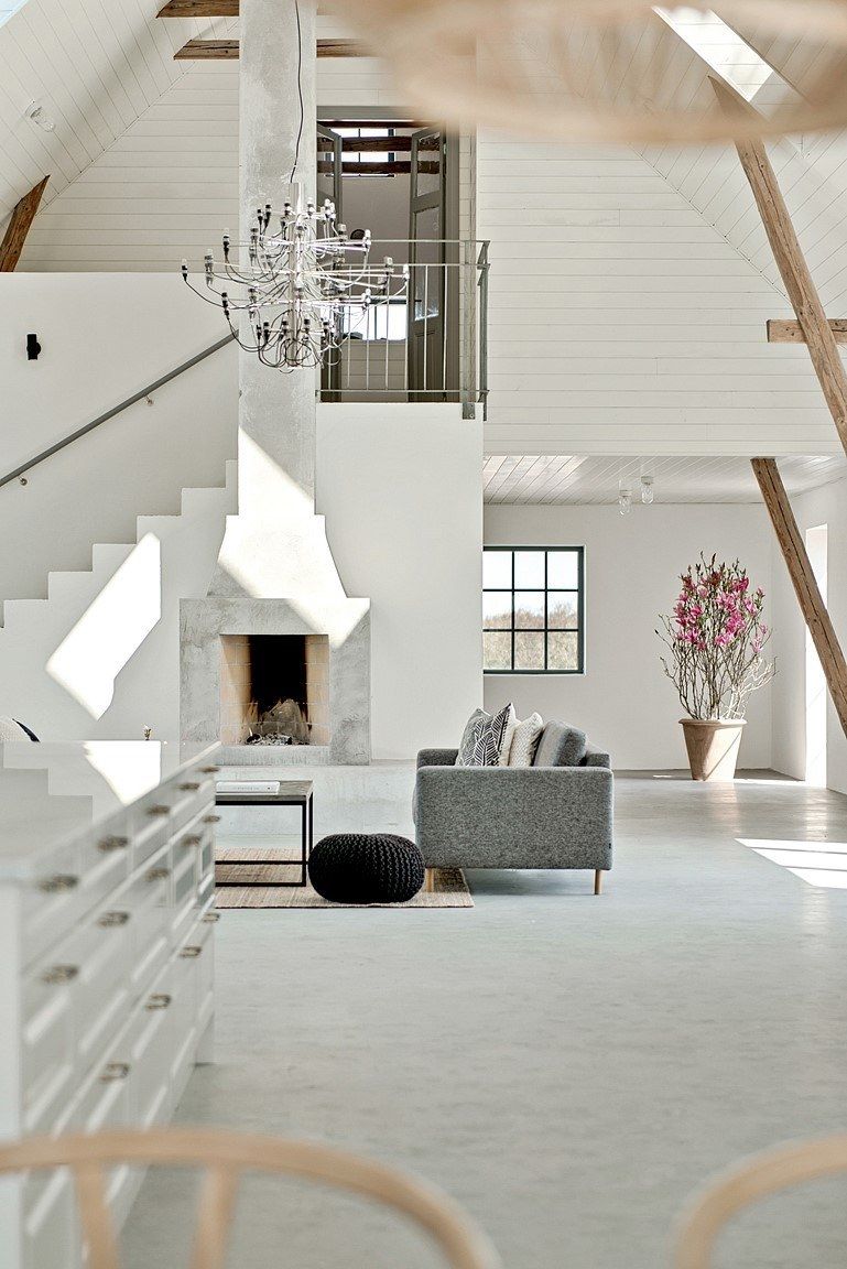The living space features a large fireplace, contemporary and comfy furniture and a stunning chandelier The living space features a large fireplace, contemporary and comfy furniture and a stunning chandelier