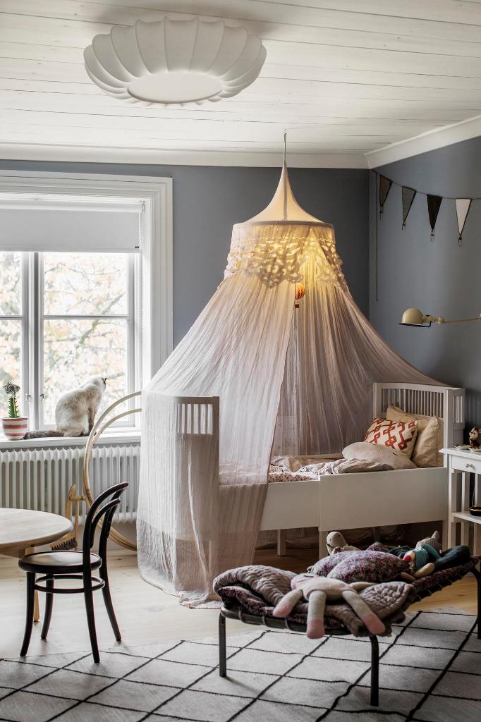 The nursery features a crib, some furniture for the parents and lots of toys