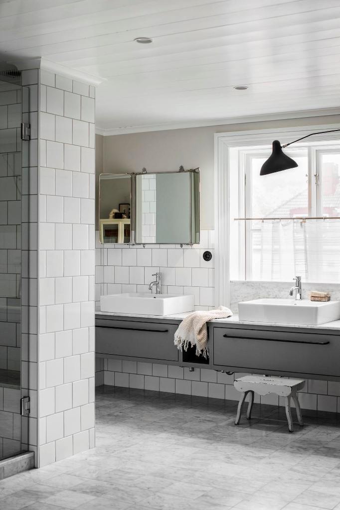 The large bathroom features two parts, a sink zone and a bathing one