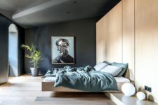 08 The large master bedroom shows off much storage and a floating bed, dark walls and a large artwork