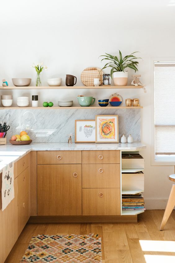 an inviting mid century modern kitchen with plywood cabinets, open shelving and bright porcelain