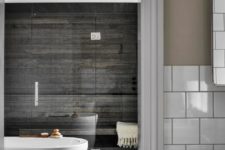 09 The second space is clad with weathered wood, there’s a shower and a large bathtub