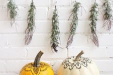 10 a duo of pumpkins decorated with a usual pen in a boho chic way look nice, a greenery garland adds a natural touch