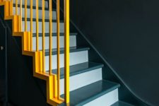 10 a staircase done in two shades of blue and spruced up with bold yellow railing for a contrast