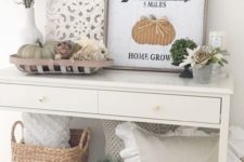 12 a simple console with faux pumpkins, a basket, a pillow, greenery and a fall sign plus fresh blooms