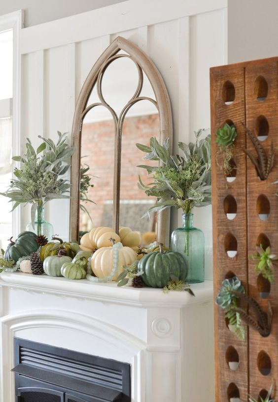a rustic Thanksgiving mantel with various pumpkins, pinecones, greenery in bottles and leaves