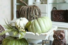 14 a vintage and rustic centerpiece with faux pumpkins in green and white and of vine is amazing for fall or Thanksgiving decor