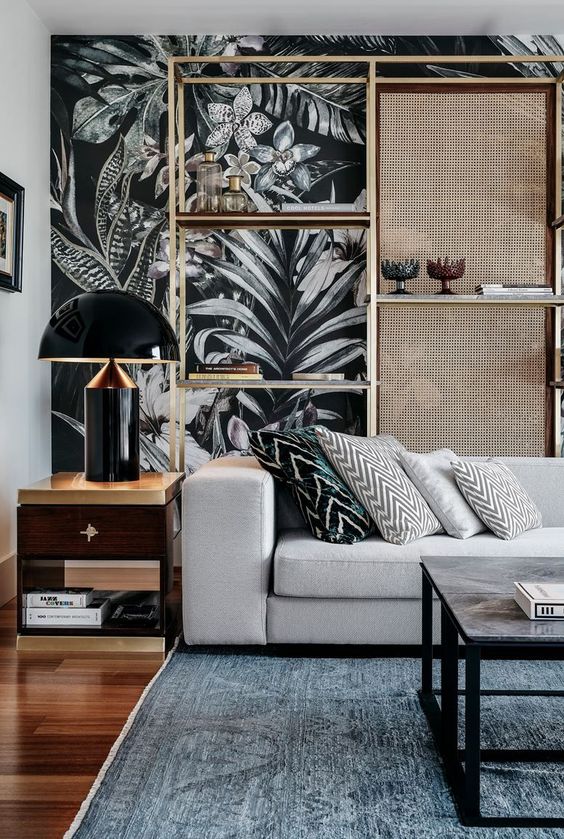dramatic moody wallpaper takes over the space and chevron pillows on the sofa add more interest