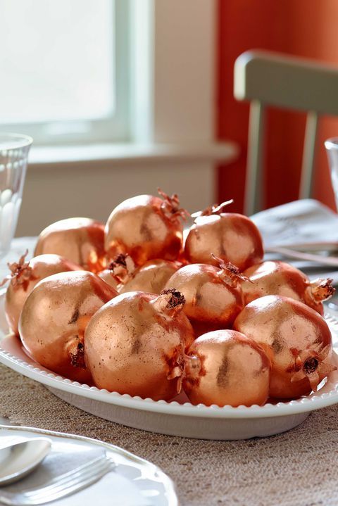 copper leaf pomegranates in a bowl can be a nice centerpiece for a fall or Thanksgiving party, and making one is easy