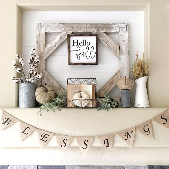 a rustic fall or Thanksgiving mantel with cotton, fabric pumpkins, herbs and a sign in a frame