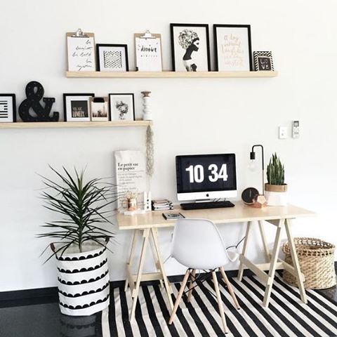a monochrome striped rug and a simple secondary print on the wrap for the pot make the space bolder