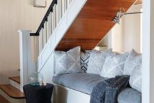 19 use the space under the stairs for an ultimate comfortable nook for reading or having a nap