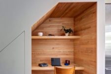 20 a small home office built in under the stairs and all clad with wood for a cozy feel