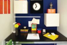 24 a home office nook with a navy wall and white drawers that create a bold color blocking effect