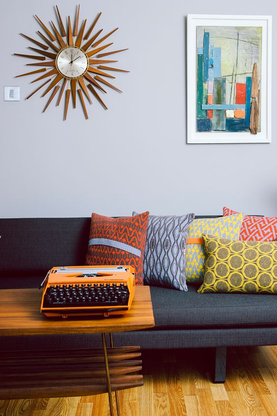 abstract pillows on the sofa make it bright and add a mid-century modern feel to it