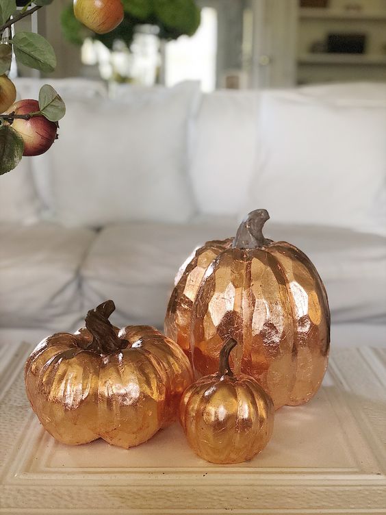 take some faux pumpkins and decorate them with copper leaf to make a simple and chic fall decoration