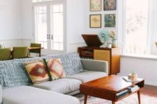 25 abstract pillows and a rug are great for sprucing up the space and making it mid-century modern