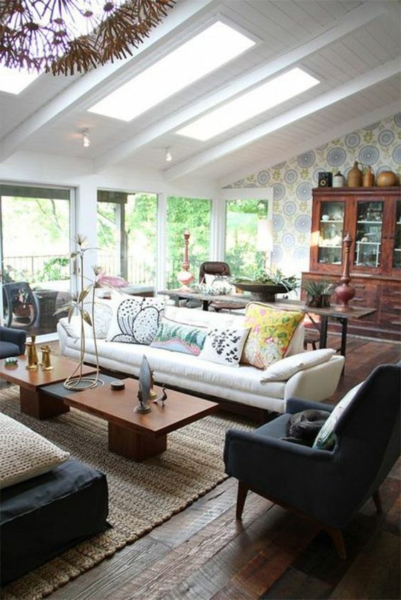 printed wallpaper in one part of the room and bright printed pillows in the next one to divide the spaces