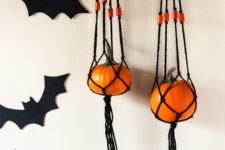 26 these fun hangers of blakc macrame and orange pumpkins are a simple and cute boho decoration for Halloween