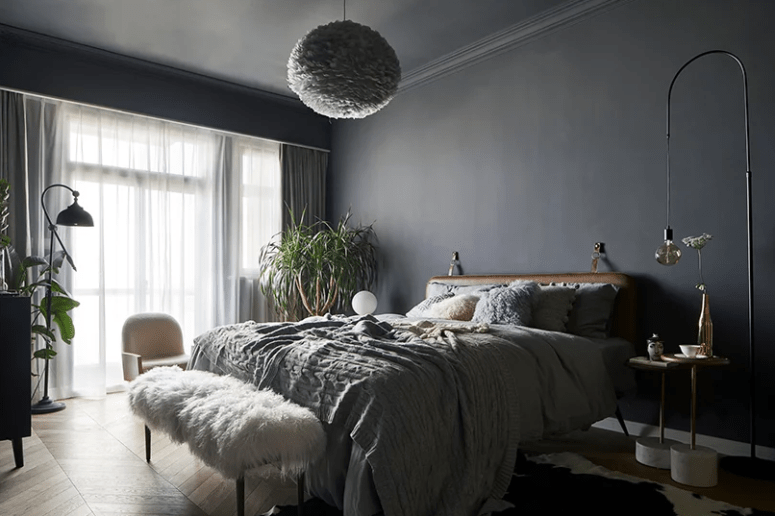 The master bedroom is grey, with a leather upholstered bed, a faux fur bench, some comfy furniture and a fluffy cloud lamp over it all The master bedroom is grey, with a leather upholstered bed, a faux fur bench, some comfy furniture and a fluffy cloud lamp over it all
