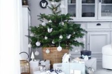 02 a small Nordic Christmas tree with lights and white and silver ornaments