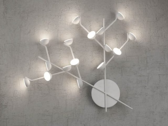 There are wall lights that show off two branches with lights