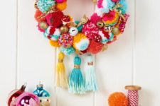 03 a super colorful and whimsy holiday wreath with pompoms, ornaments, fake mushrooms and large tassels