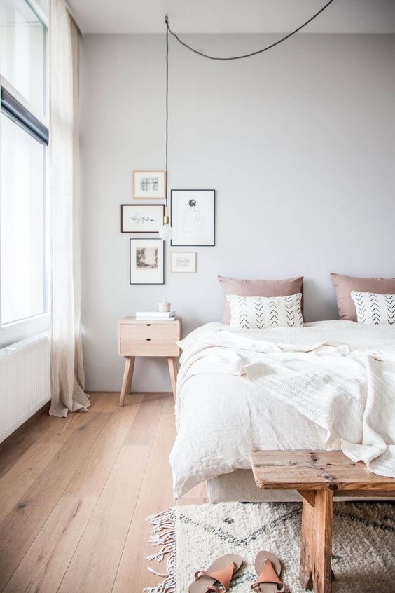 a welcoming and airy Scandinavian bedroom with all-natural linens and a touch of dusty pink