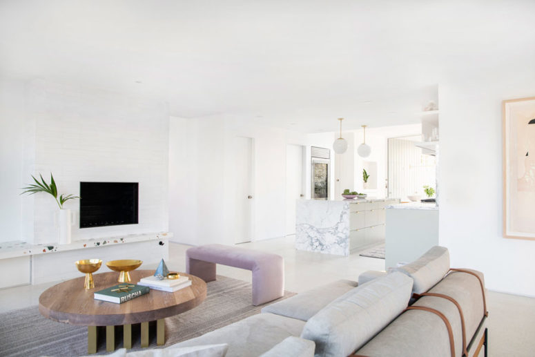 The living room is united with the kitchen that goes next and is also filled with light