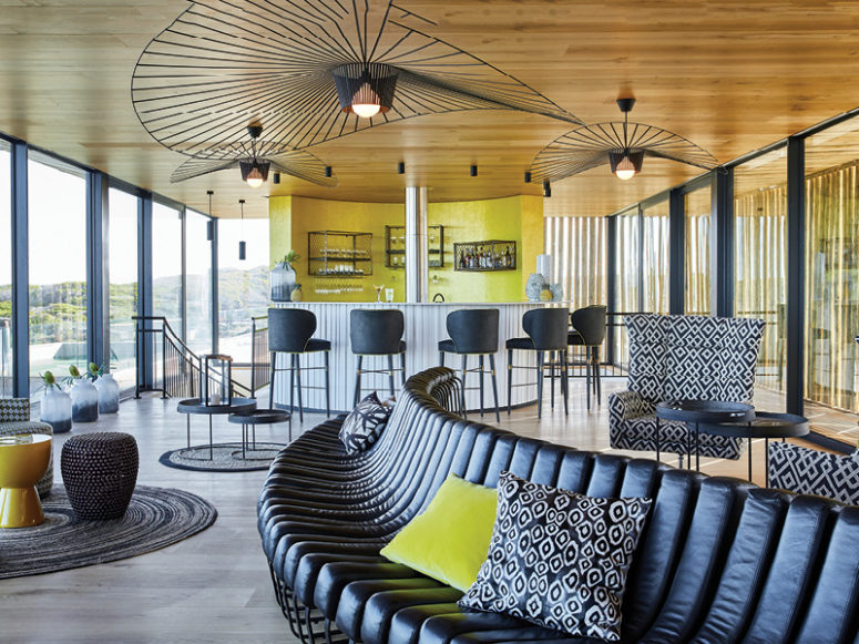 The lounge is done with neutrals and black and is spruced up with bright yellow touches here and there