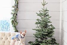 04 a small Christmas tree placed into a wooden crate filled with emerald ornaments is a modern farmhouse idea