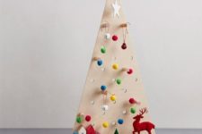 05 a little pegboard Christmas tree with pompom and jingle bell ornaments hanging on hooks
