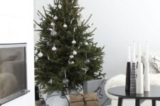 05 a modern Scandi Christmas tree with white, clear and metallic ornaments and no lights for a laconic look