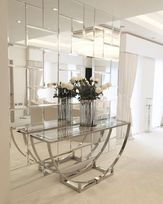 bring a fun glam feel to your space adding such a geometric mirror wall and a glass console table