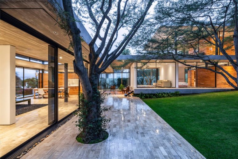 Outside, there are decks with trees integrated