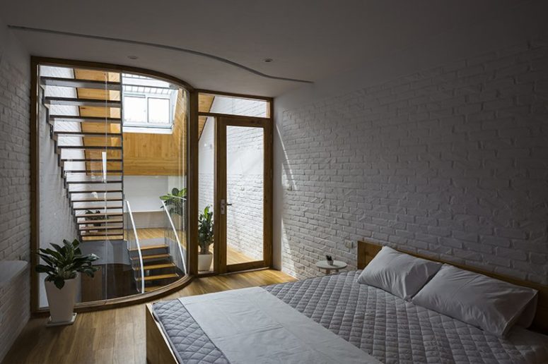 bedroom with minimalist bedside tables The bedroom is a simple space with a large bed, bedside tables and some plants