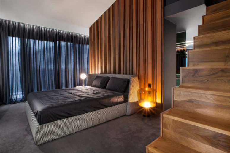 bedroom with mismatched tables The master bedroom features a wooden wall, a glazed wall that can be covered with curtains and mismatching bedside tables
