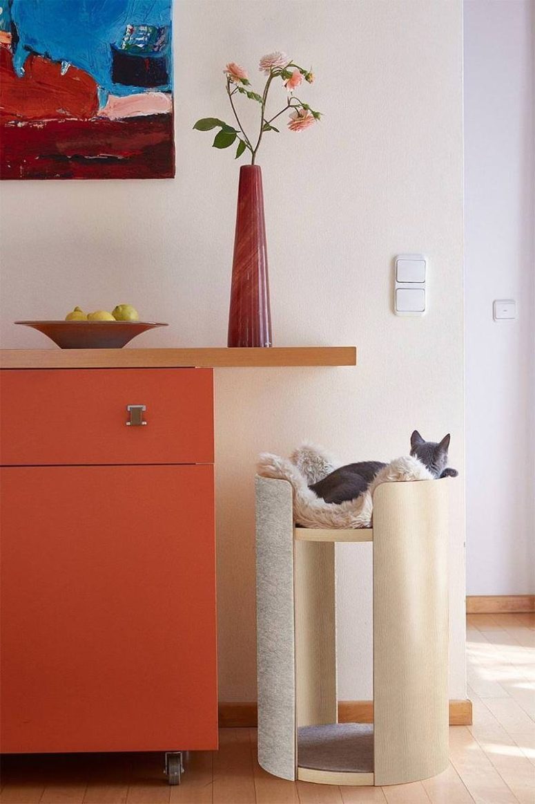 This tall and stylish cat bed is a scratcher at the same time and a faux fur throw for comfort