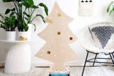 07 a cute plywood Christmas tree decorated withh lights and colorful and metallic stickers on it