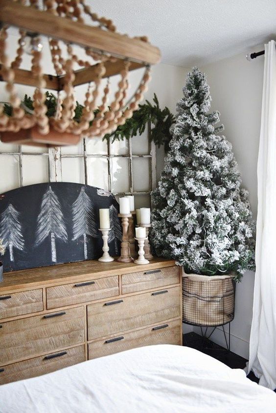 a small flocked Christmas tree in a metal wire basket with no decor at all - it looks cool without it