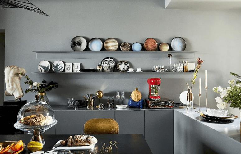 The kitchen is also an art-filled space, an open shelving unit shows off gorgeous ceramics