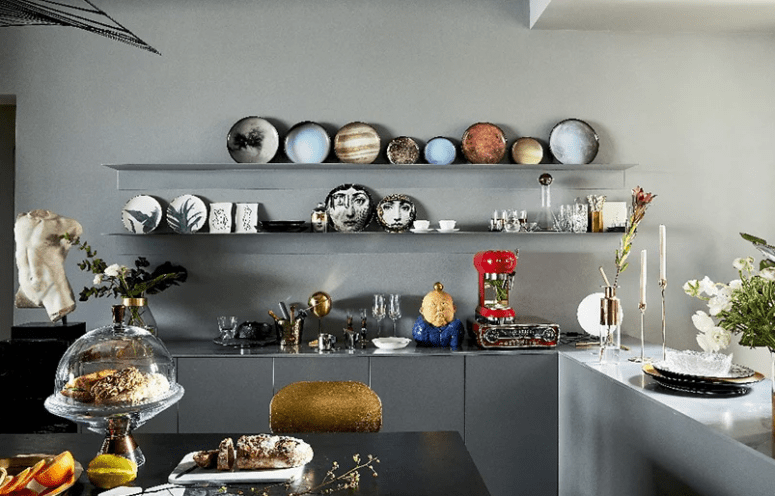 The kitchen is also an art filled space, an open shelving unit shows off gorgeous ceramics The kitchen is also an art-filled space, an open shelving unit shows off gorgeous ceramics