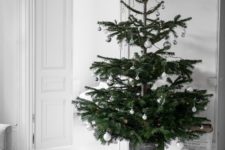 08 a Nordic Christmas tree with silver and white ornaments in a galvanized bucket is a chic idea for a modern space