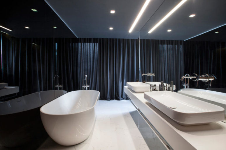 The master bathroom is next to it, it's done in white and navy and the wall between it and the closet is of smoked glass The master bathroom is next to it, it's done in white and navy and the wall between it and the closet is of smoked glass