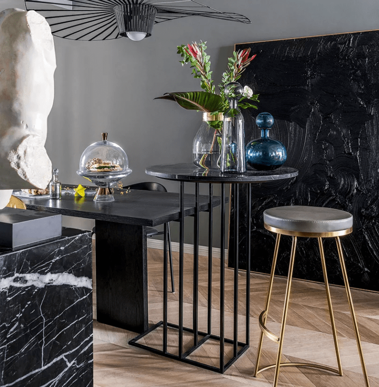 The space is done with various tables, stools and some art that impresses The space is done with various tables, stools and some art that impresses