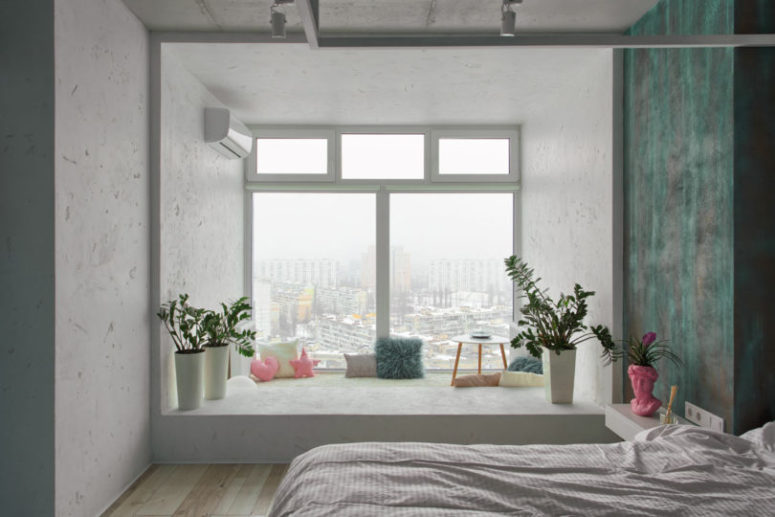 There's a gorgeous comfy windowsill zone with pillows, plants and a low table