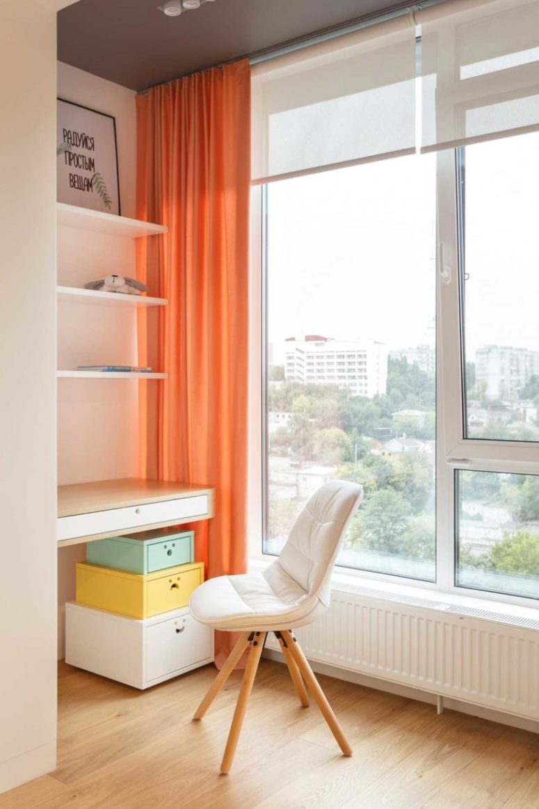 The home office is a comfy nook by the window, with several shelves, dressers and a floating desk