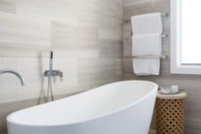 11 a contemporary bathroom all clad with tiles and with a wooden coffee table – add textures for interest