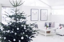 11 a modern Nordic Christmas tree with white ornaments plus bows and a star on top