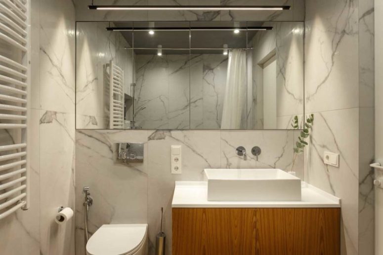 The second bathroom is done with the same materials, and there's a bathtub